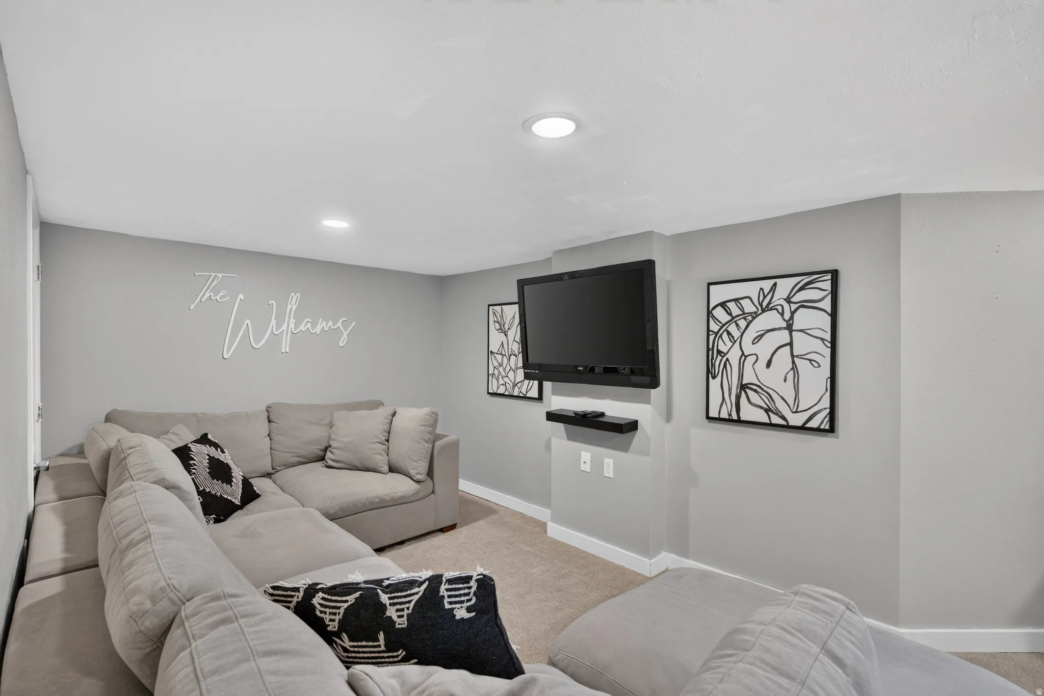 Carpeted interior space featuring light gray walls, white trim, and recessed lighting