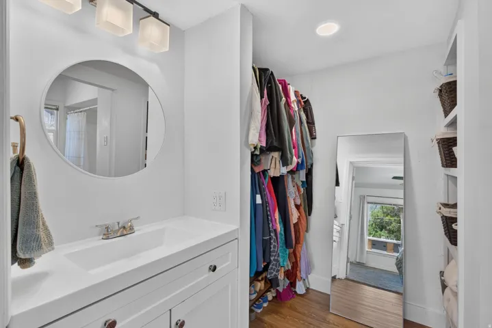 Vanity area featuring a rectangular undermount sink, white countertop, and wall-mounted light fixture