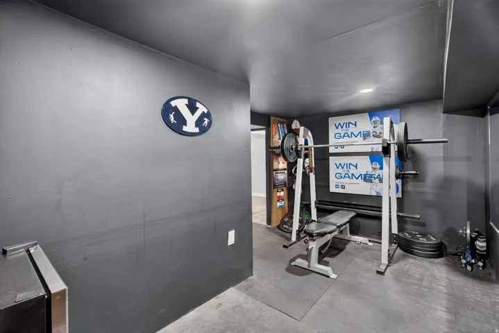 Dedicated fitness area featuring dark gray walls and ceiling