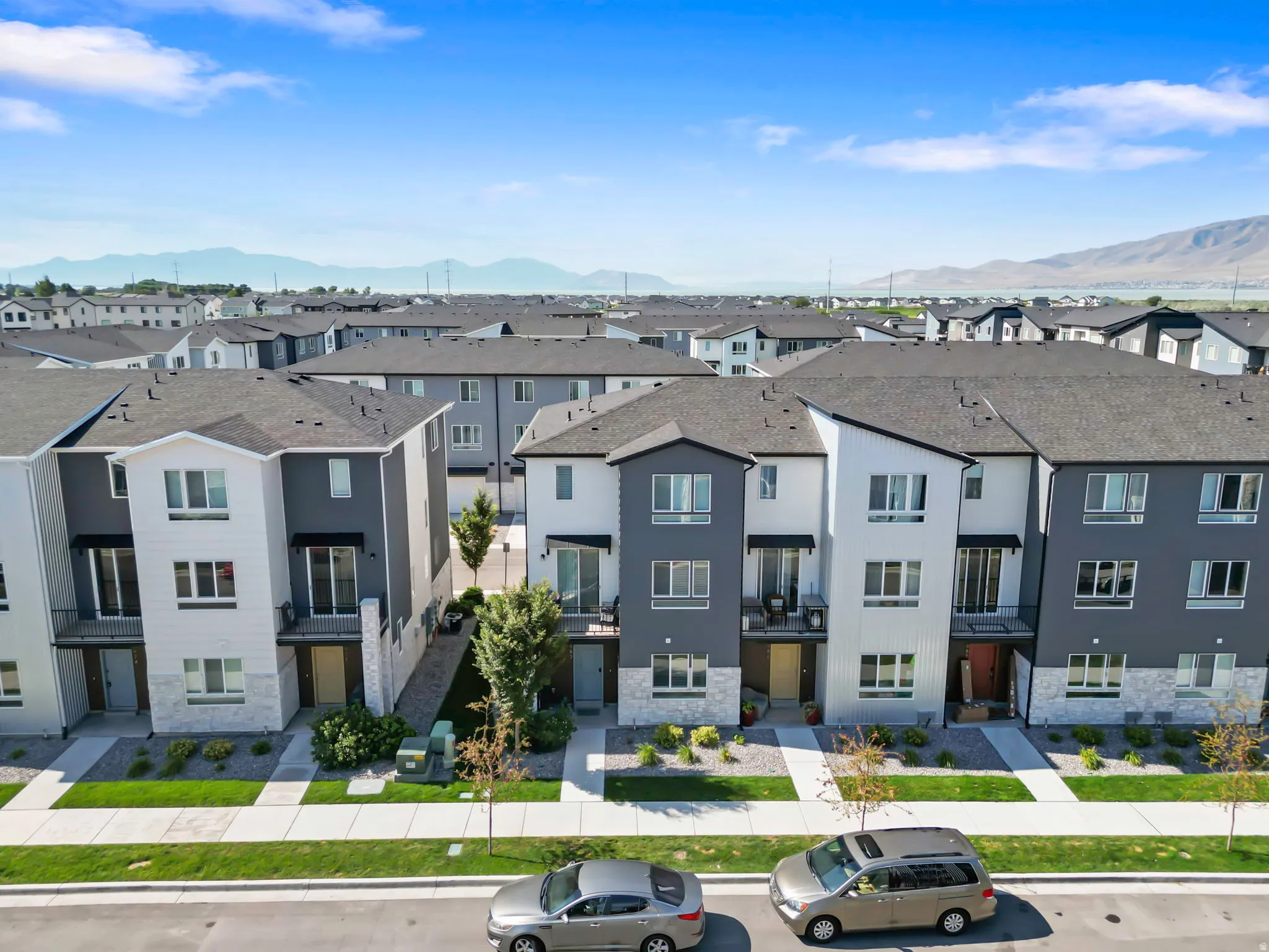 Modern townhome facades featuring contrasting white and dark gray siding