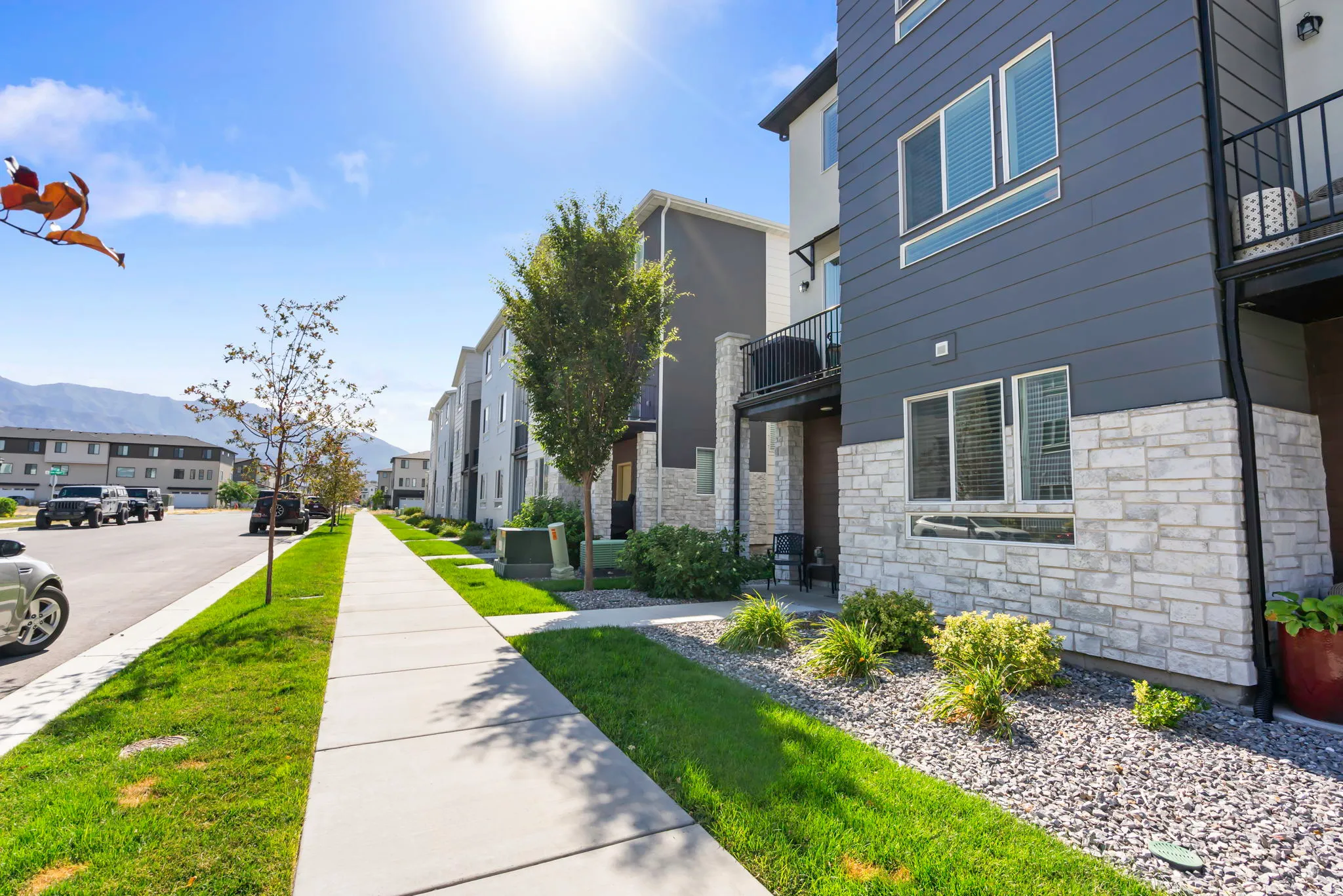 Modern multi-story exterior with stone veneer and horizontal siding
