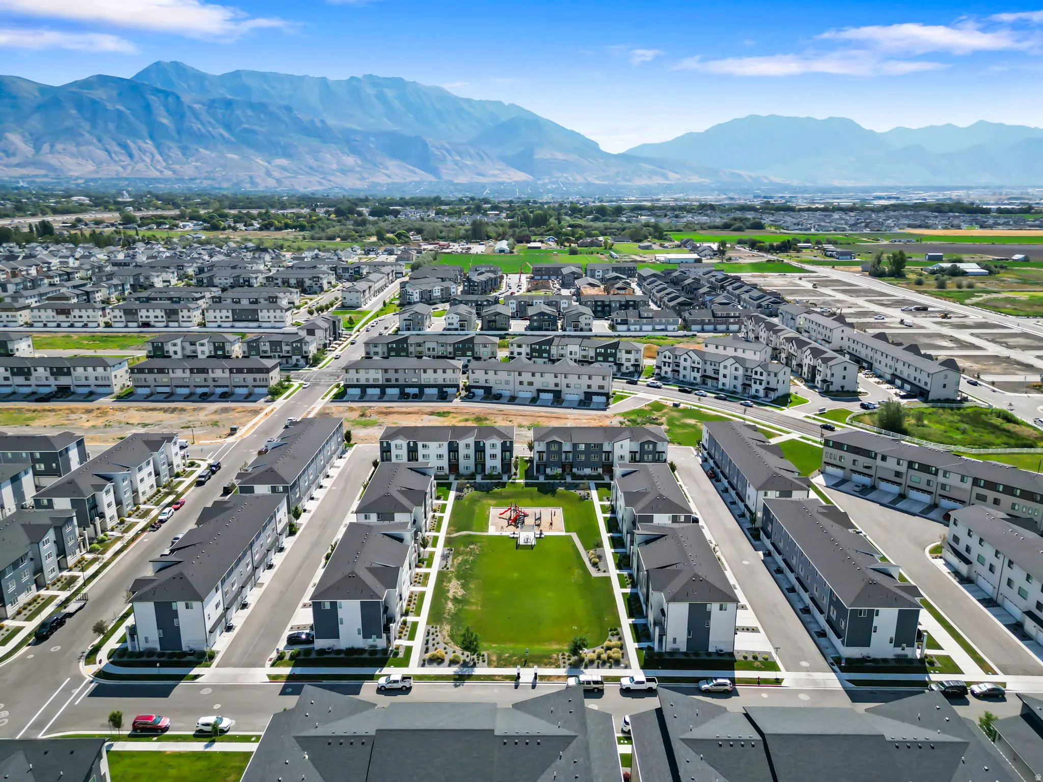 Aerial perspective showcasing a community of multi-story residences with diverse exterior finishes
