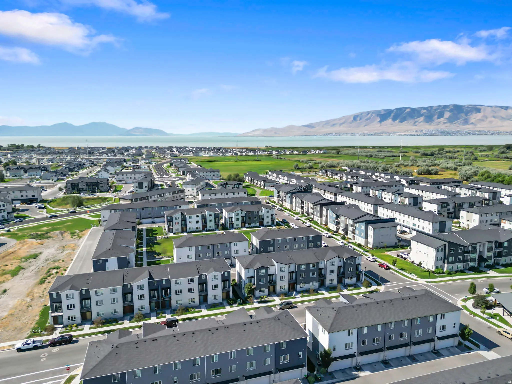 Modern multi-story residential buildings featuring contemporary architecture and dark-toned roofing