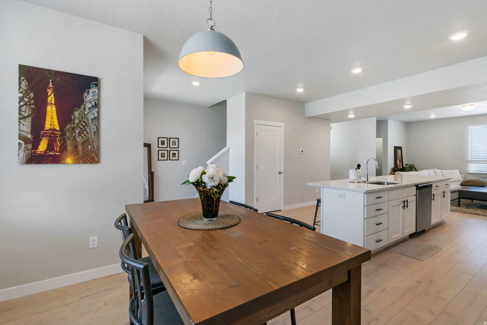 Open-concept living space with light wood-finish flooring
