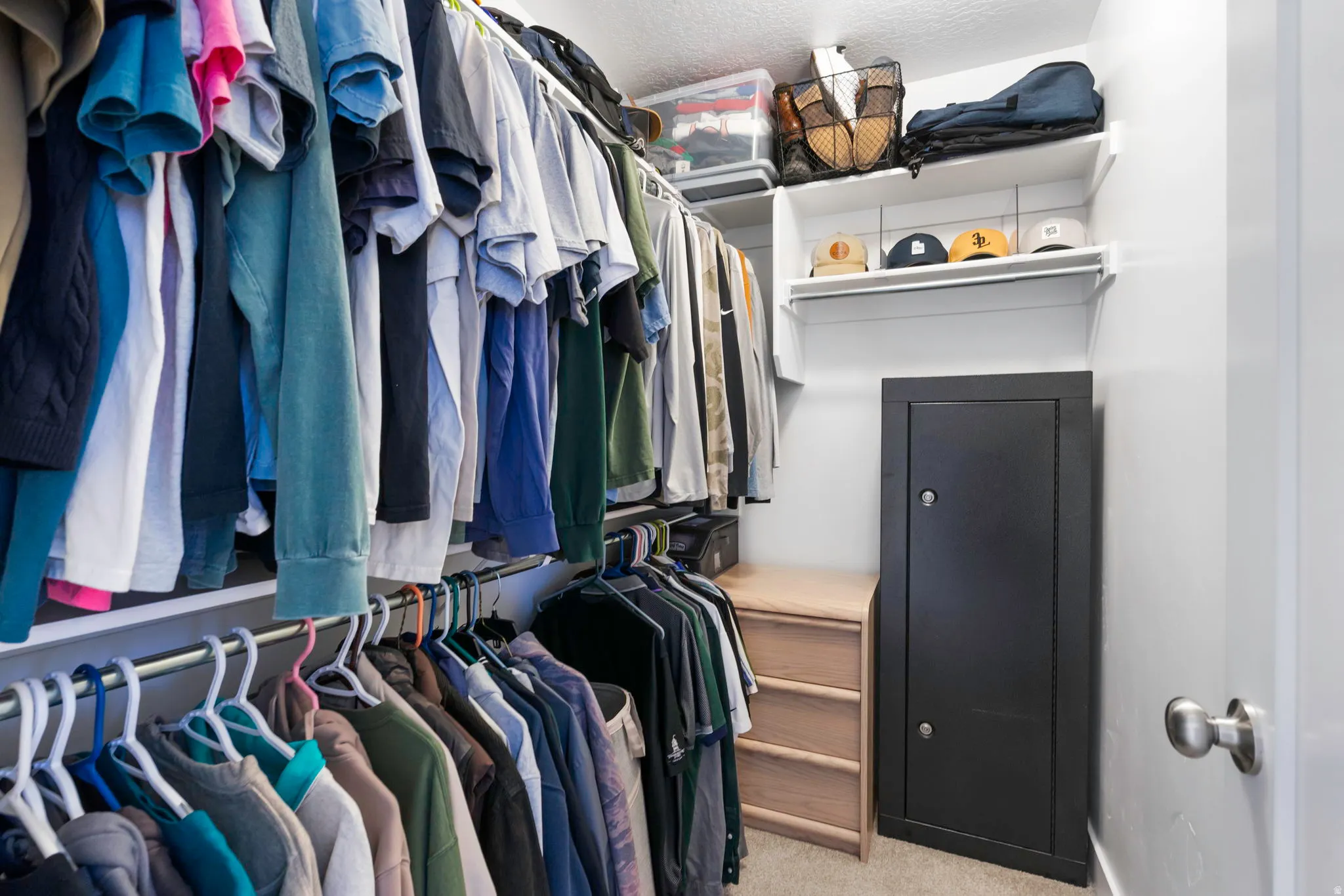 Integrated closet system featuring multiple hanging rods, upper shelving, and built-in drawers