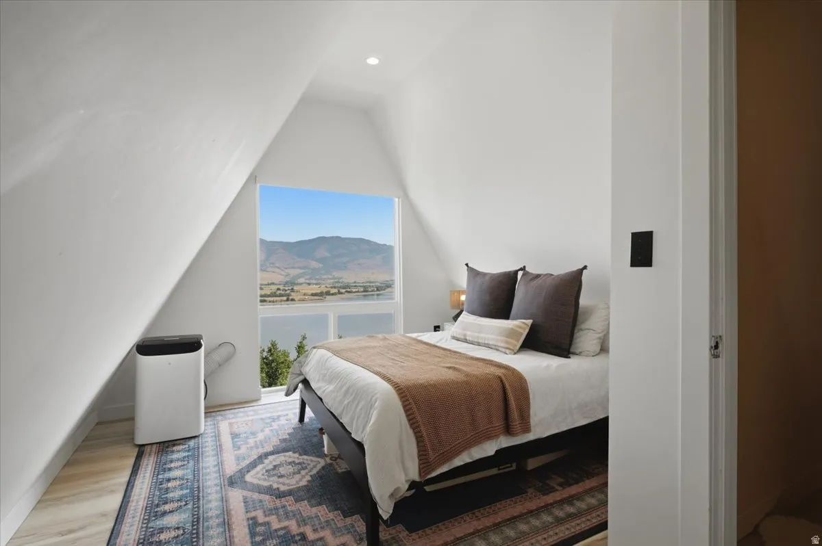 Room featuring a large picture window, a recessed ceiling light, and wood-finish flooring