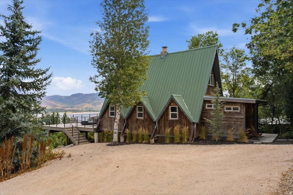 A-frame property featuring a green metal roof and wood siding