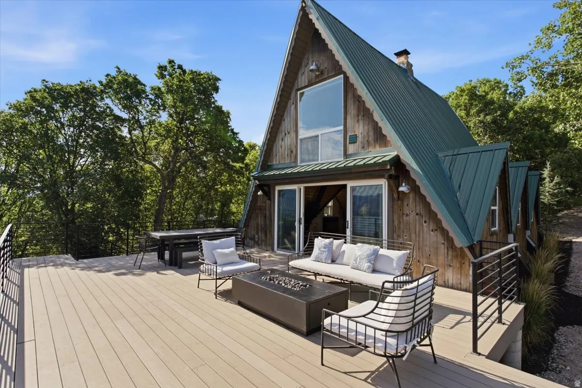 A-frame style residence featuring a wood-plank exterior and a green metal roof