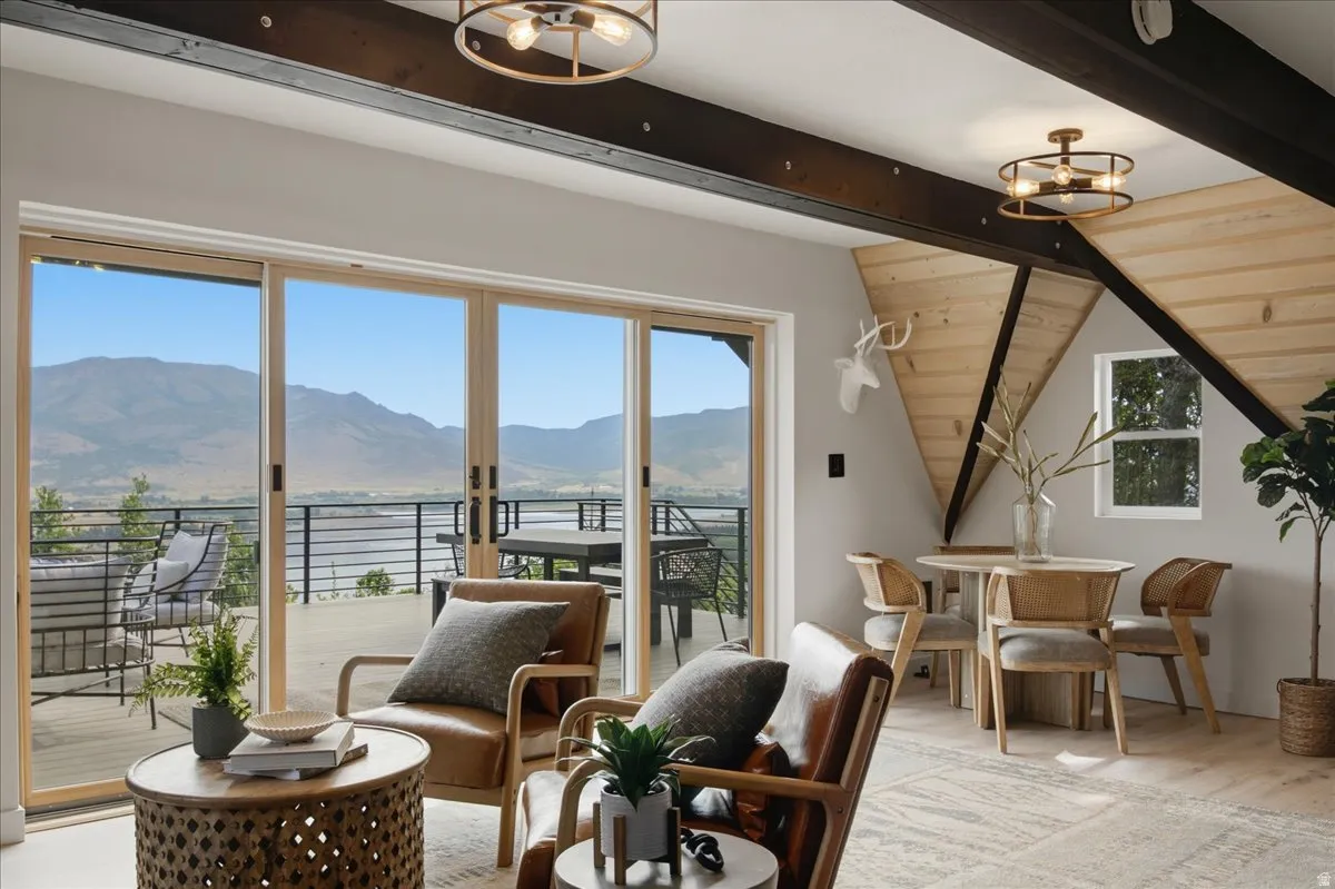 Sliding glass doors opening onto a deck with mountain scenery