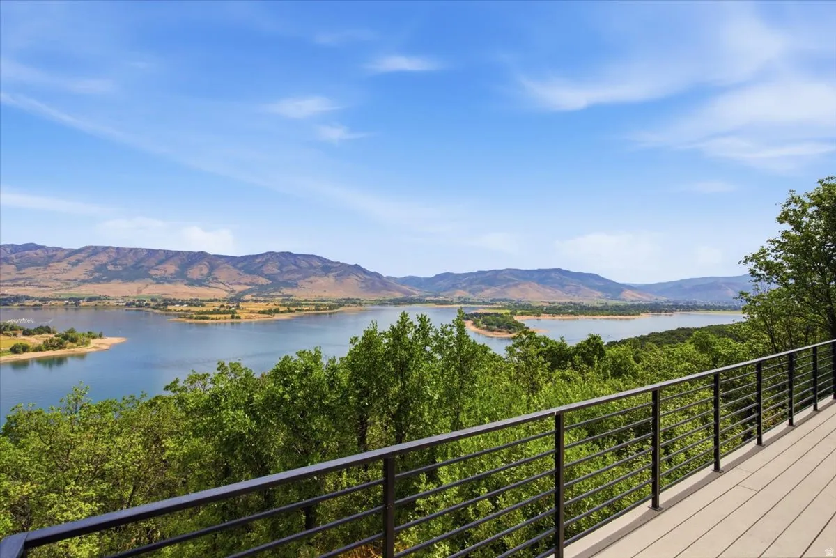 Expansive outdoor decking featuring composite material and a black metal railing system