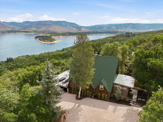 A-frame style residence with a green metal roof and wood siding