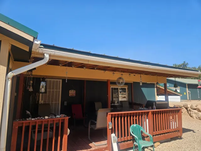 Wood-finish deck featuring a stained wood railing and a covered patio area