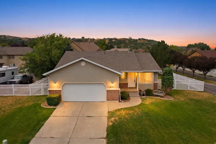 Ranch-style residence featuring a prominent front-facing garage with an automatic door