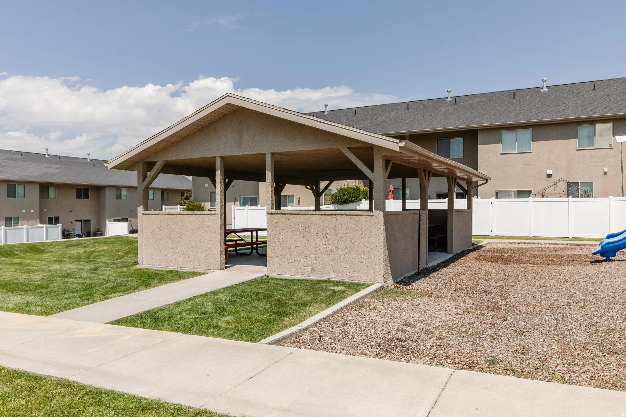 Covered outdoor pavilion with an asphalt shingle roof