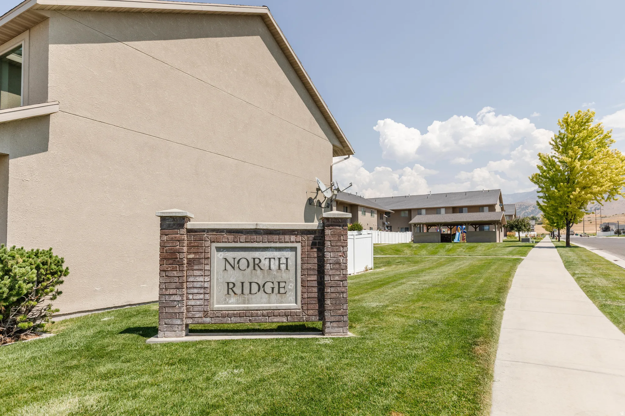 Brick and stone monument sign featuring "North Ridge" text
