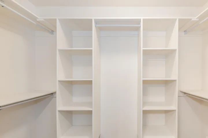Built-in closet organization system featuring shelving and hanging rods