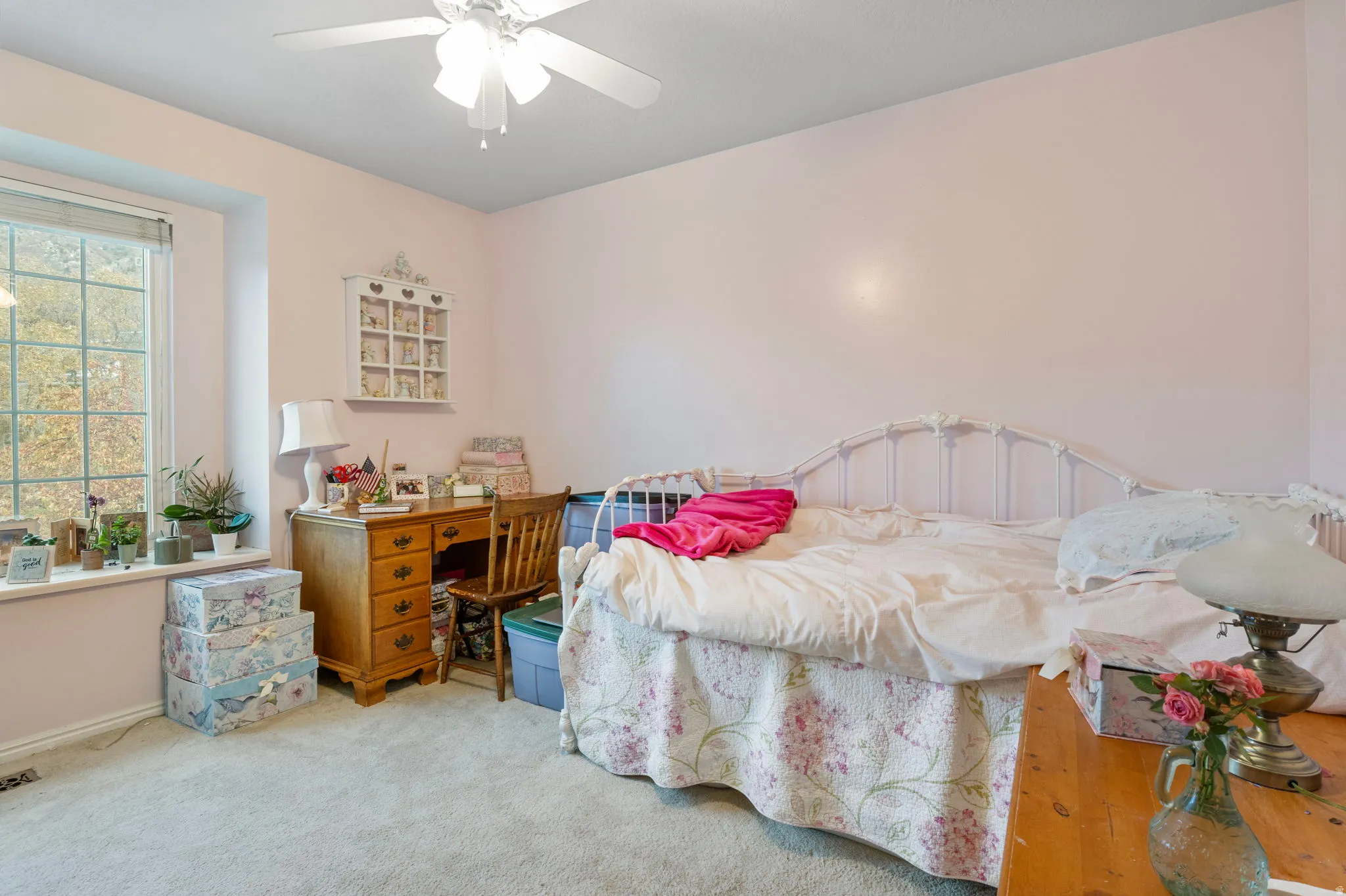Room featuring light-colored walls, carpeted flooring, and a ceiling fan