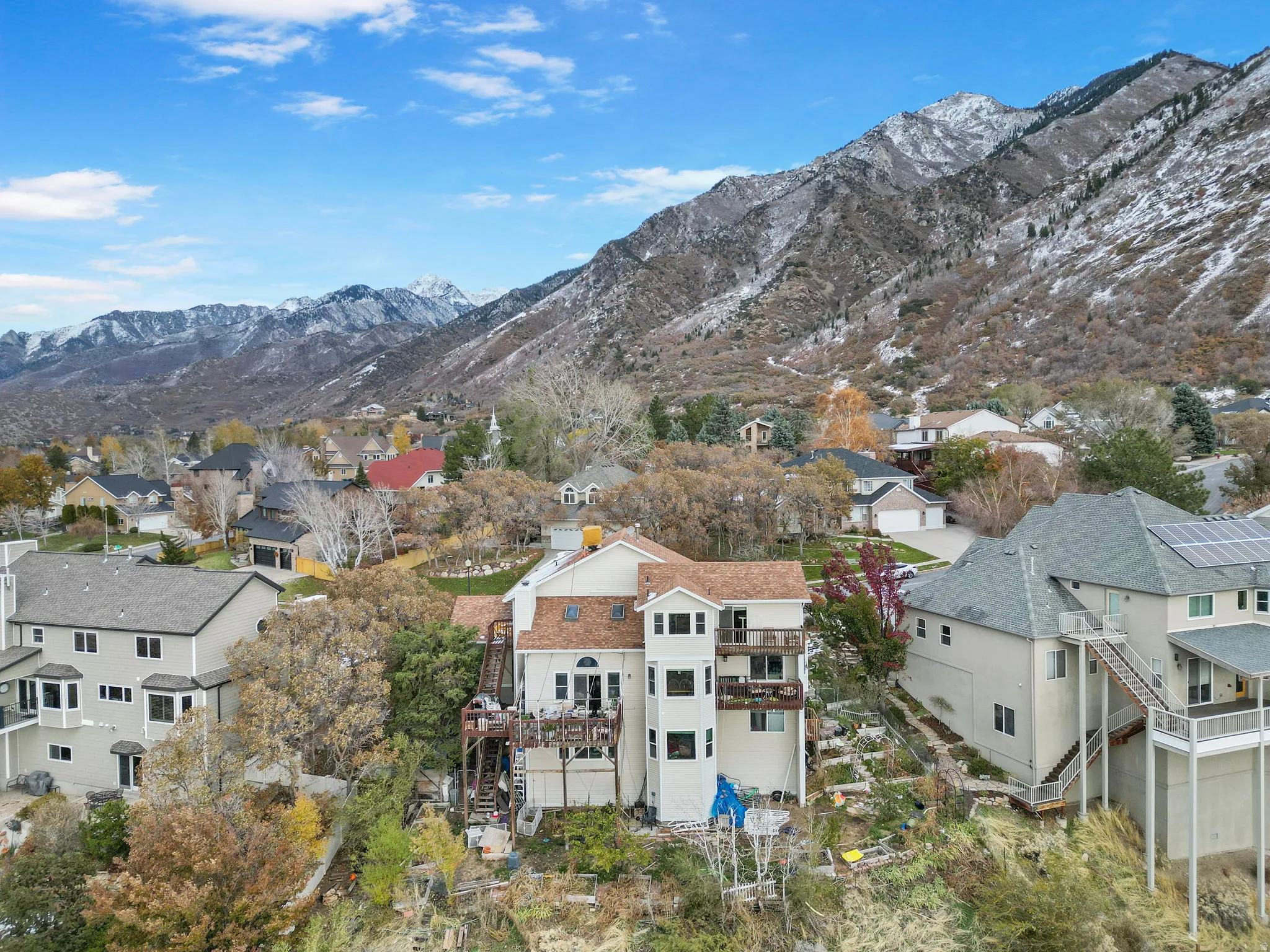 Multi-level residence featuring a terraced design, multiple private balconies, a three-story architectural tower, and an expansive deck