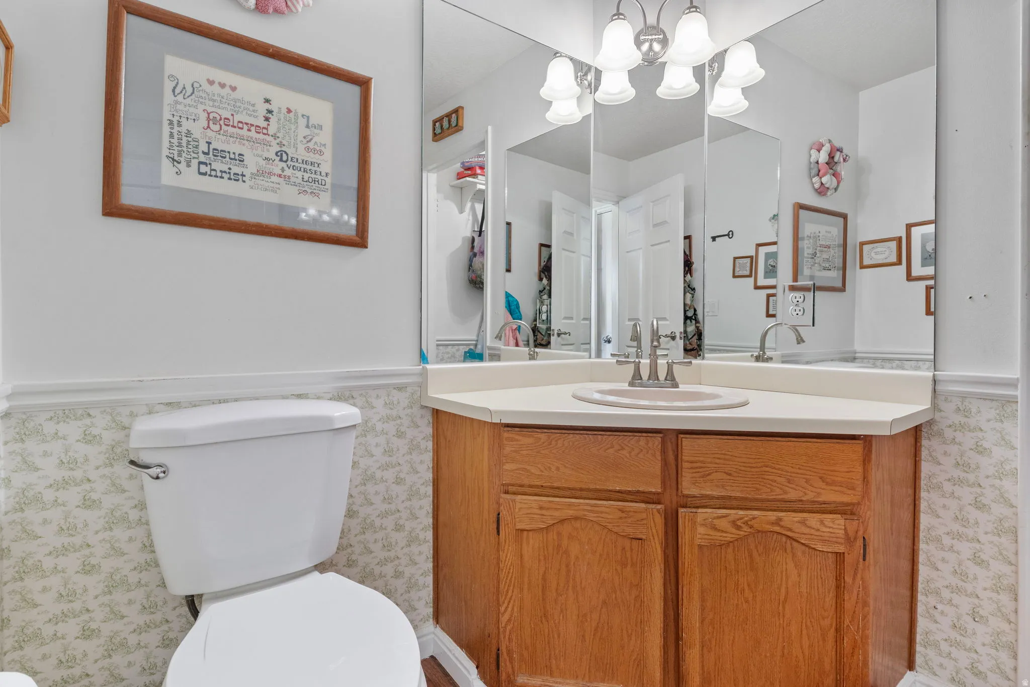 Vanity with a light wood-finish cabinet, integrated sink, and light countertop