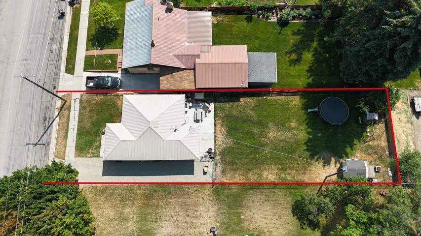 Aerial perspective showcasing the property's perimeter, a pitched roofline, and a spacious rear yard