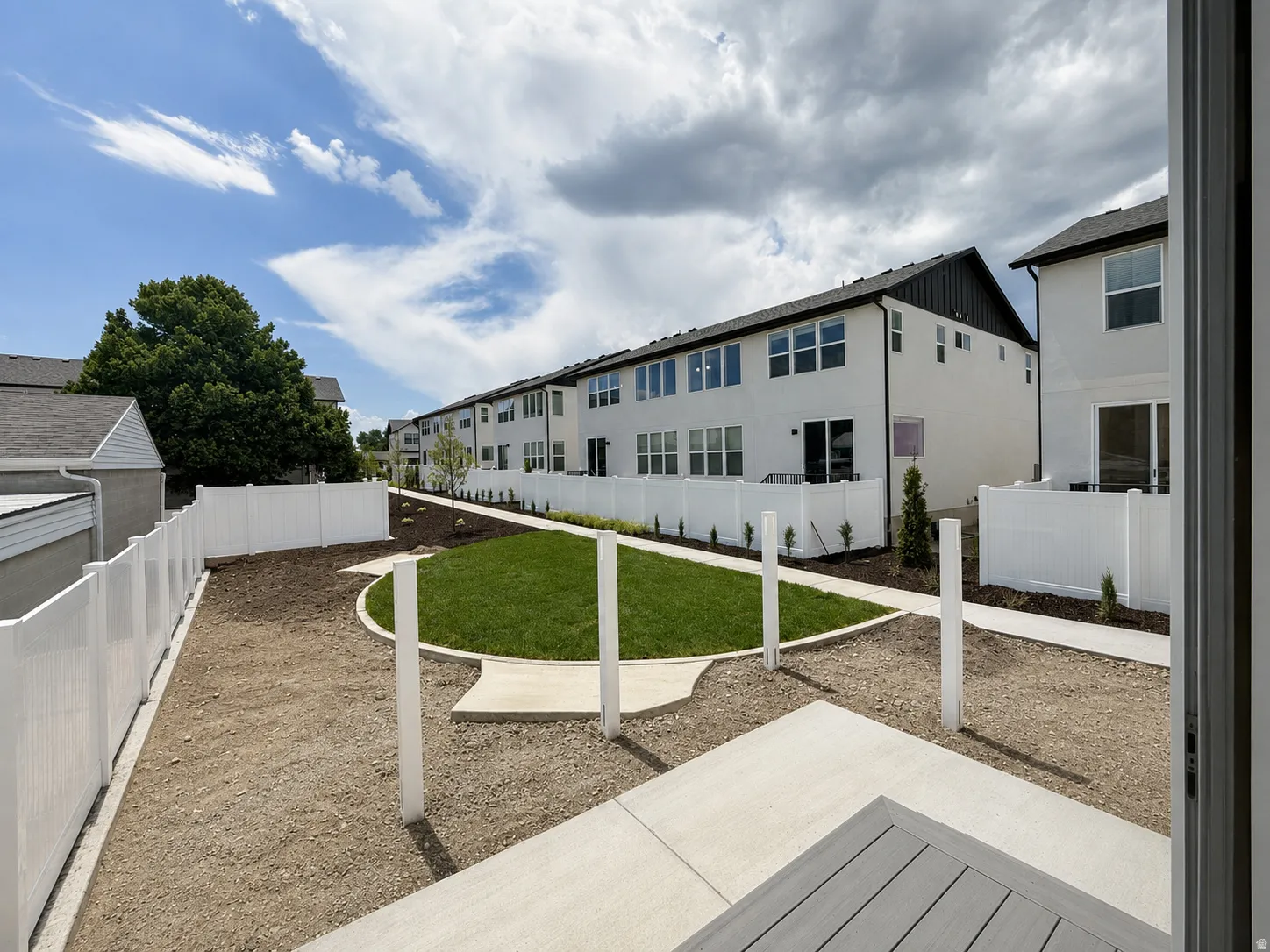 Private backyard featuring a composite deck, concrete patio, and a fenced perimeter