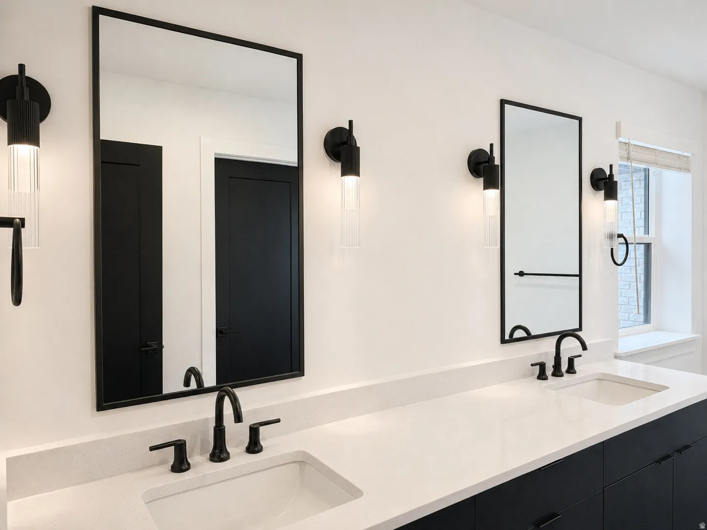 Dual vanity with matte black fixtures and square-framed mirrors