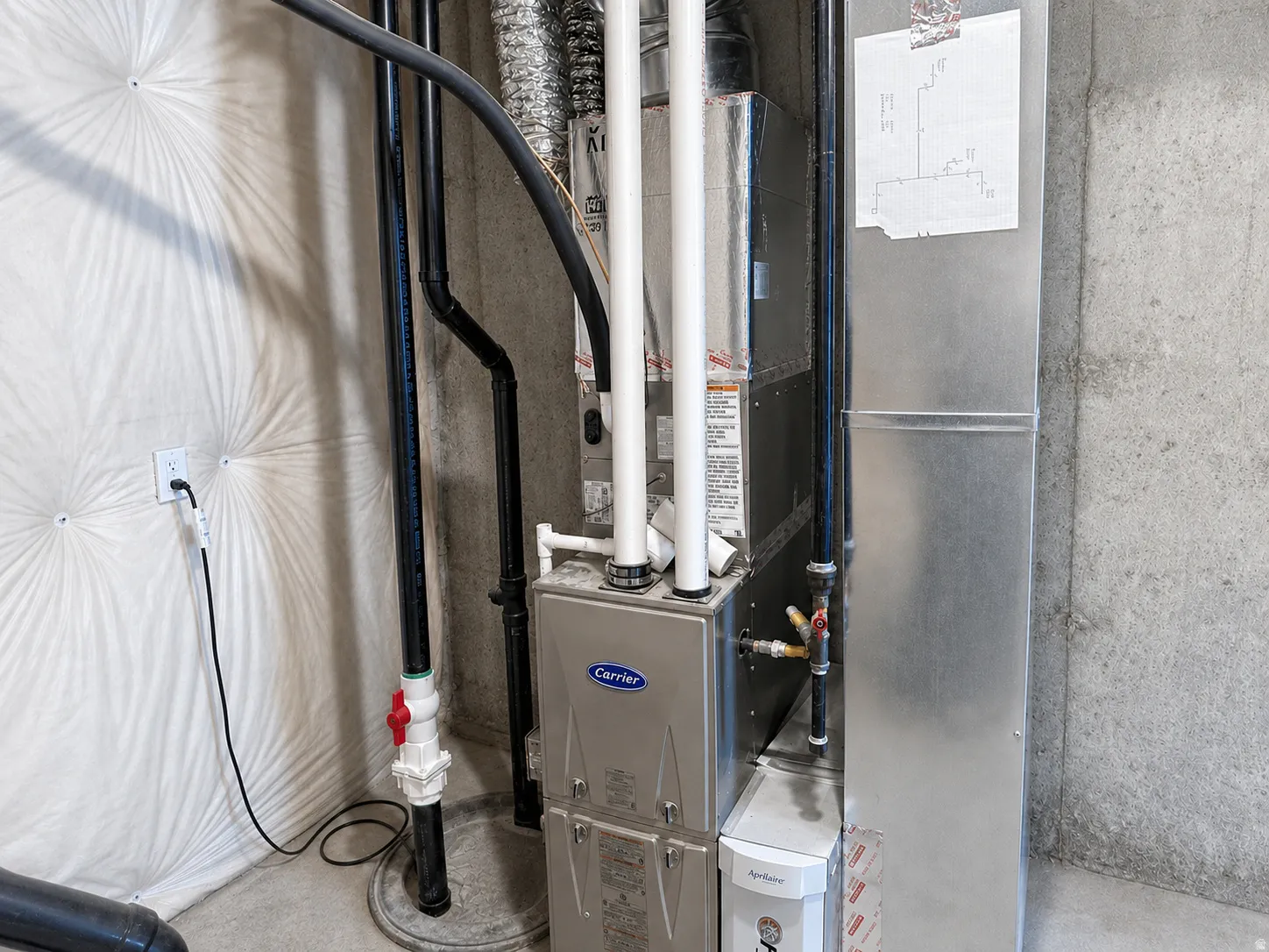 Carrier furnace unit with accompanying ductwork and exposed piping