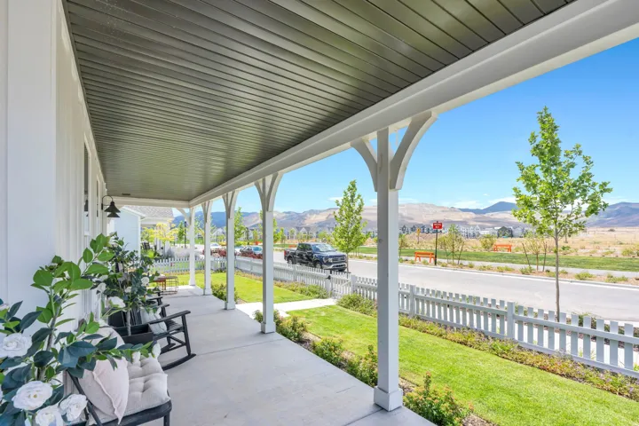 Inviting covered front porch with white columns and arched supports