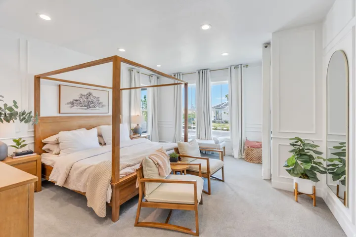 Spacious room featuring multiple windows with abundant natural light, recessed lighting, wall paneling, and light gray carpeting