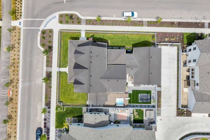 Expansive property featuring a multi-gabled roofline, manicured green lawns, and mature trees