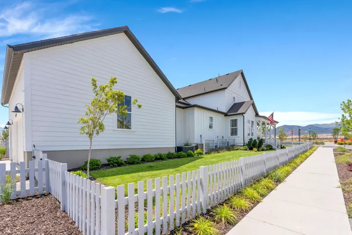 White picket fence enclosing a manicured lawn