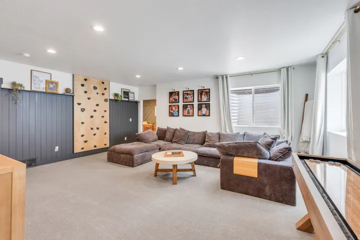 Lower-level recreation space featuring recessed lighting and light-toned carpeting