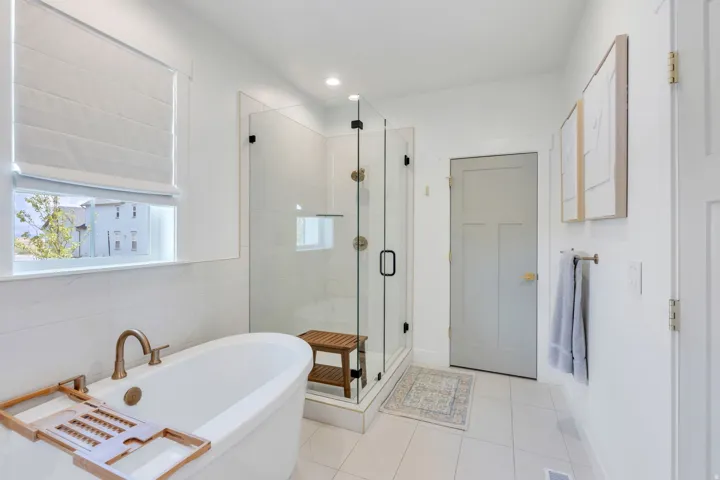 White freestanding soaking tub with bronze-finish fixtures