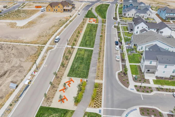 Aerial perspective showcasing a developing community with new construction homes and established residences