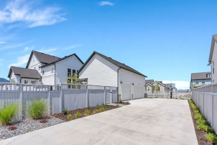 Expansive concrete driveway servicing a two-car garage
