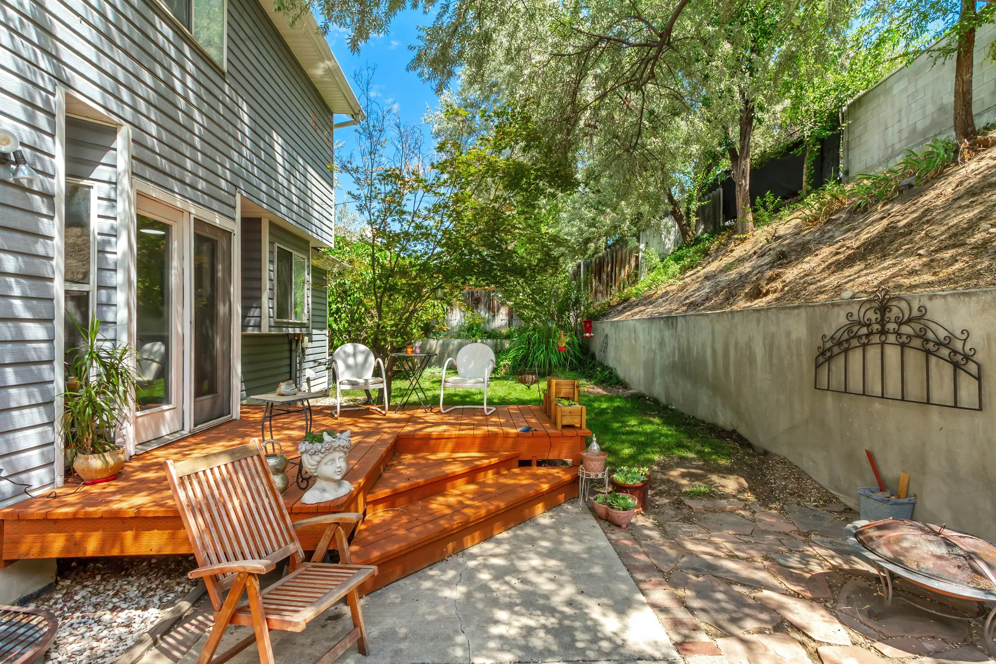 Tiered wood deck with multiple levels, featuring direct access to the interior via a glass-paneled door