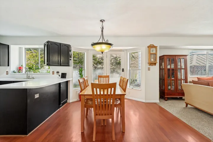 Dining area featuring wood-finish flooring and a central chandelier
