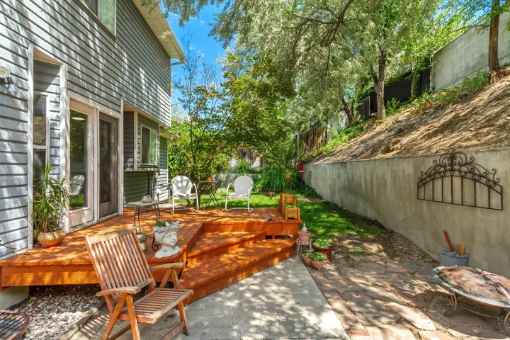 Tiered wood deck with multiple levels, featuring direct access to the interior via a glass-paneled door