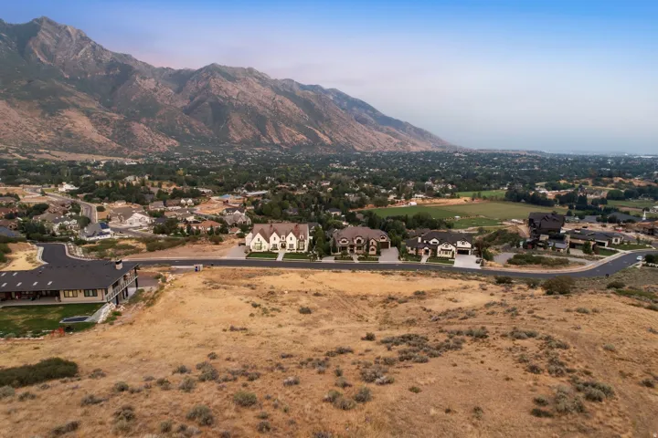 Expansive lot with mountain backdrop, offering a gently sloped terrain