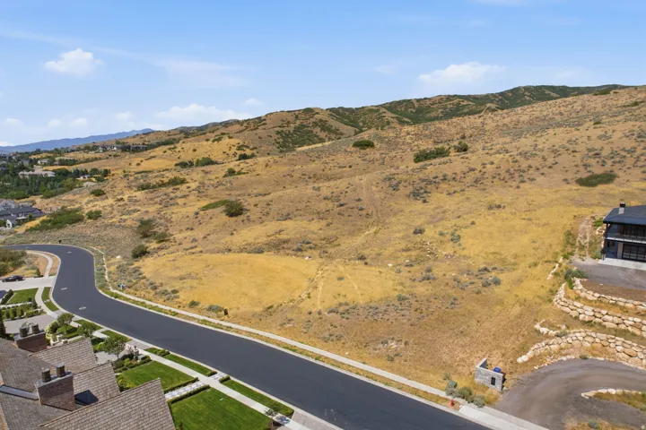 Expansive undeveloped land parcel featuring natural terrain and distant mountain ranges
