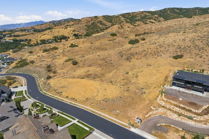 Expansive undeveloped land parcel featuring natural terrain and distant mountain ranges