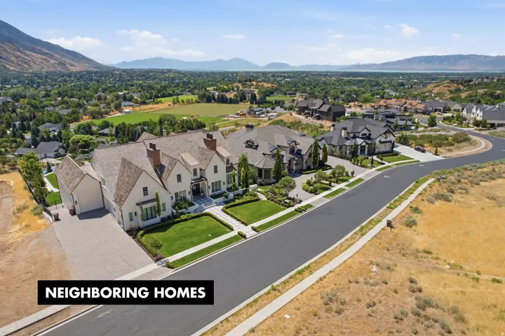 Expansive property situated on a paved street with mountain and distant water scenery