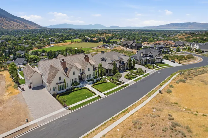 Contemporary estate featuring a multi-gabled roofline and light-colored siding