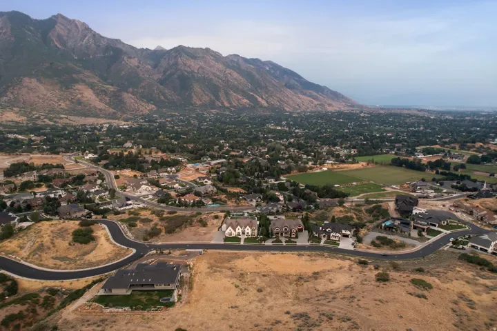 Developing residential community with paved roads and mountain backdrop