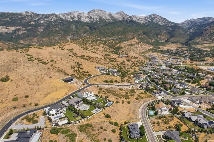 Expansive aerial perspective showcasing a residential community nestled against a mountainous backdrop