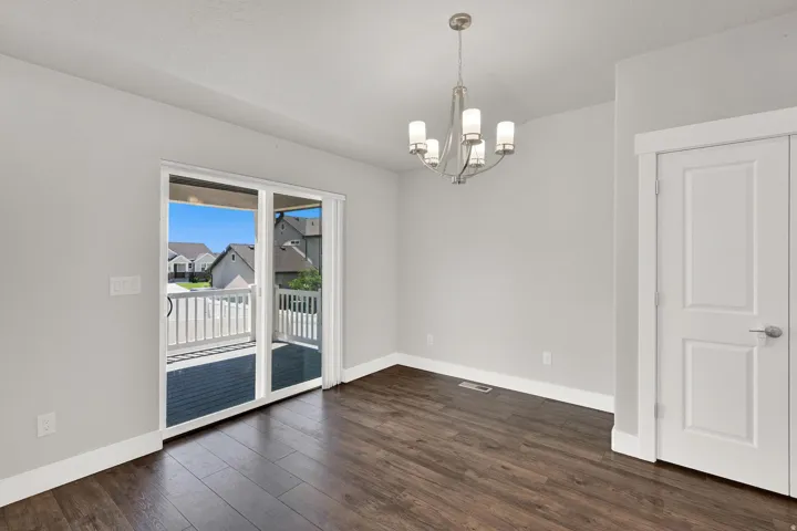 Sliding glass door opening to an outdoor deck with white railings