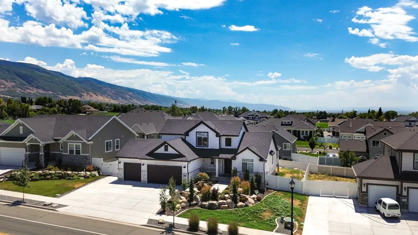 Contemporary residence featuring a white and dark gray exterior with stone accents
