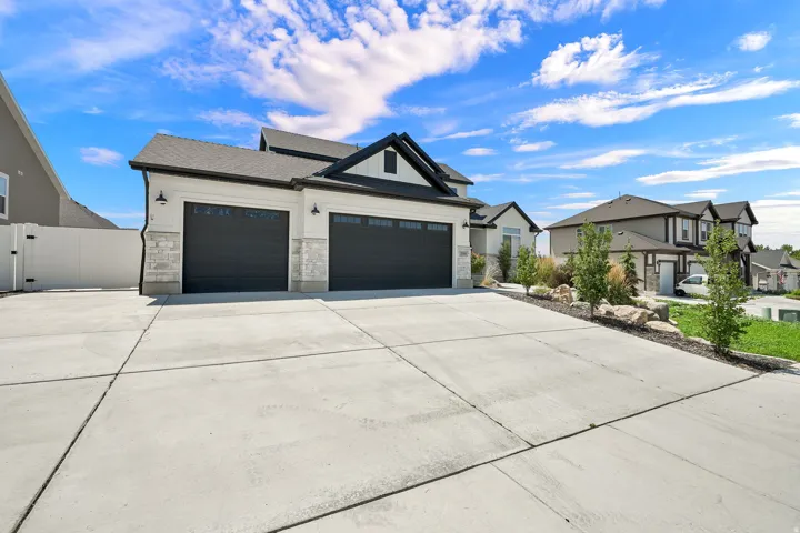 Three-car garage and RV parking with black doors and transom windows.