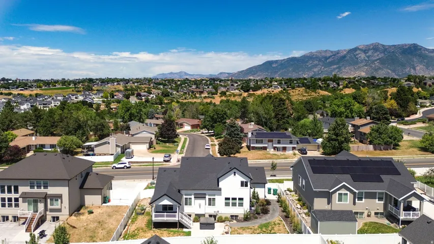 Aerial perspective showcasing a residential neighborhood with distant mountain ranges