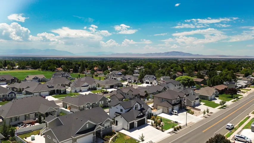 Residential neighborhood featuring a mix of single-story and two-story homes with dark shingle roofs